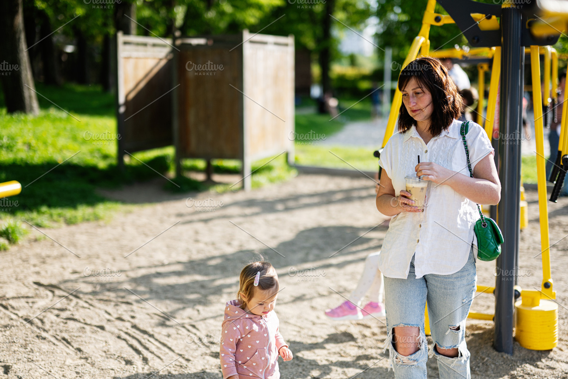Mother and child enjoying a sunny day at a local playground, a Person Photo by AS photostudio