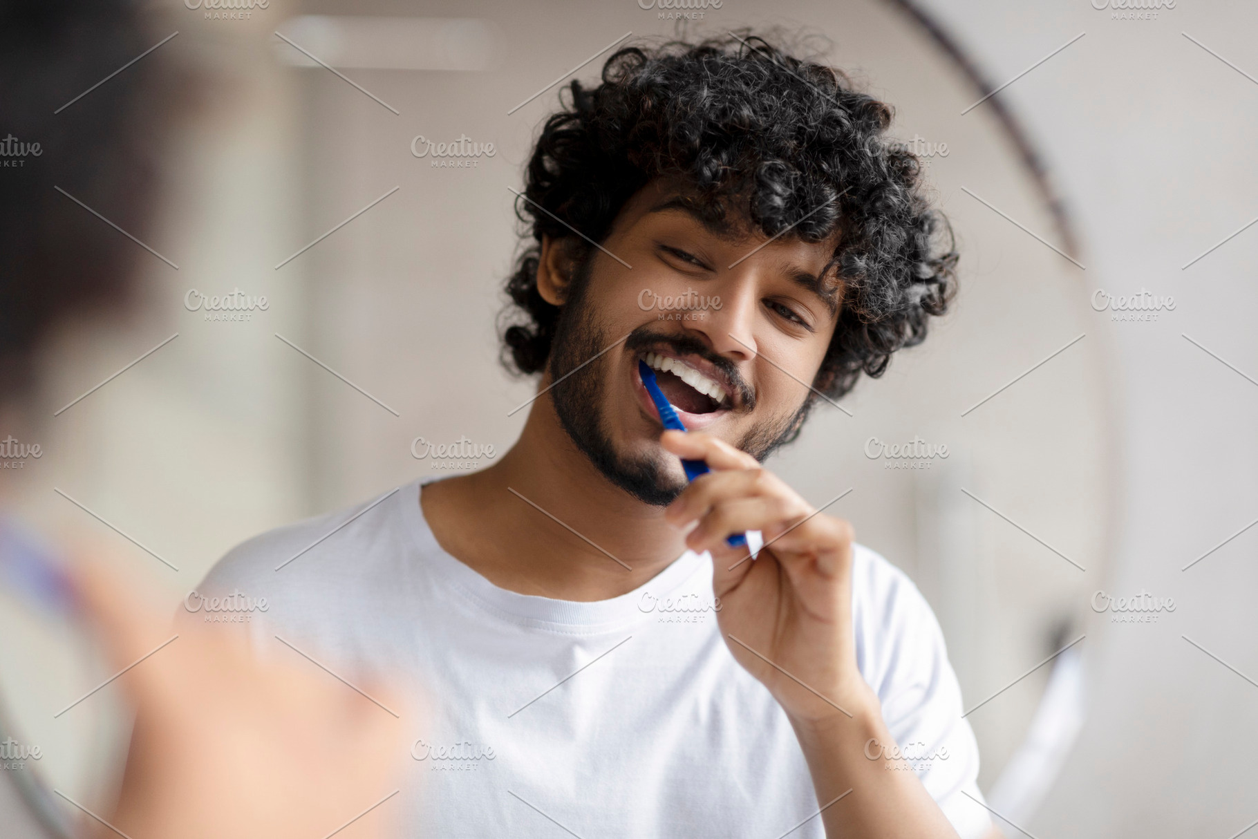 Oral care concept. Young indian man cleaning teeth with toothbrush, smiling to, a Person Photo by Prostock-Studio