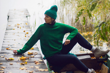 portrait of a fashionable beautiful brunette woman in a green sweater and hat s, a Person Photo by SaulichPhoto