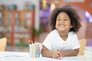 Happy girls are painting in library containing art, drawing, and artist