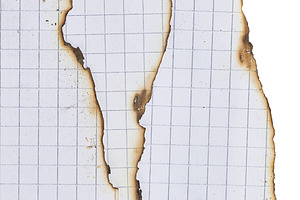 Torn and burnt edges of squared notebook sheets, close up, an Abstract Photo by ndanko