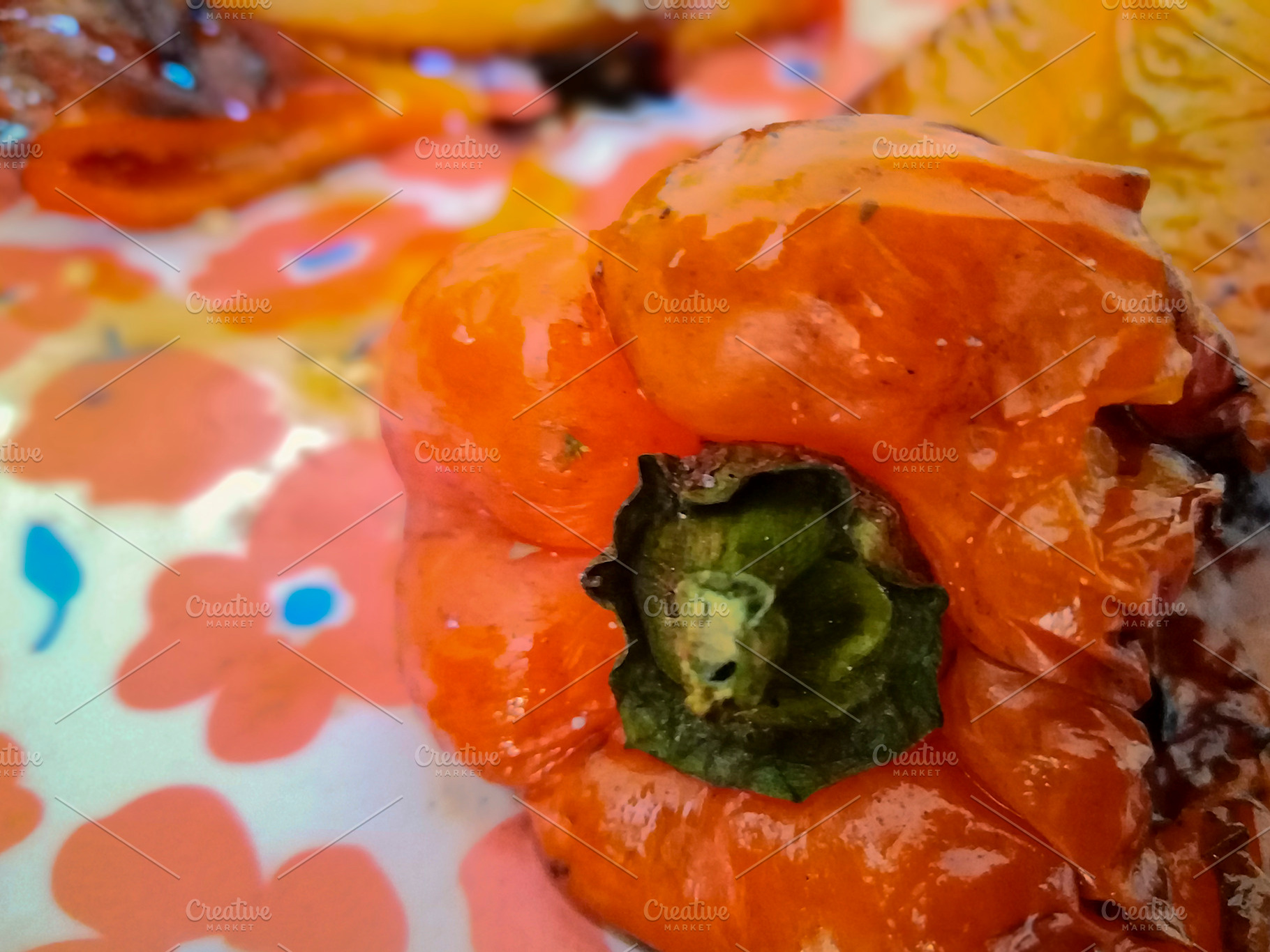 Extreme close-up of roasted red pepper on floral plate, a Food & Drink Photo by DanFLCreativo