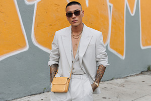Influencer man displays summer fashion near vibrant street art, a Person Photo by OSORIOartist