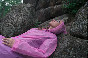 Woman in the taiga forest and rocks, a Person Photo by Jan Jack Russo Media