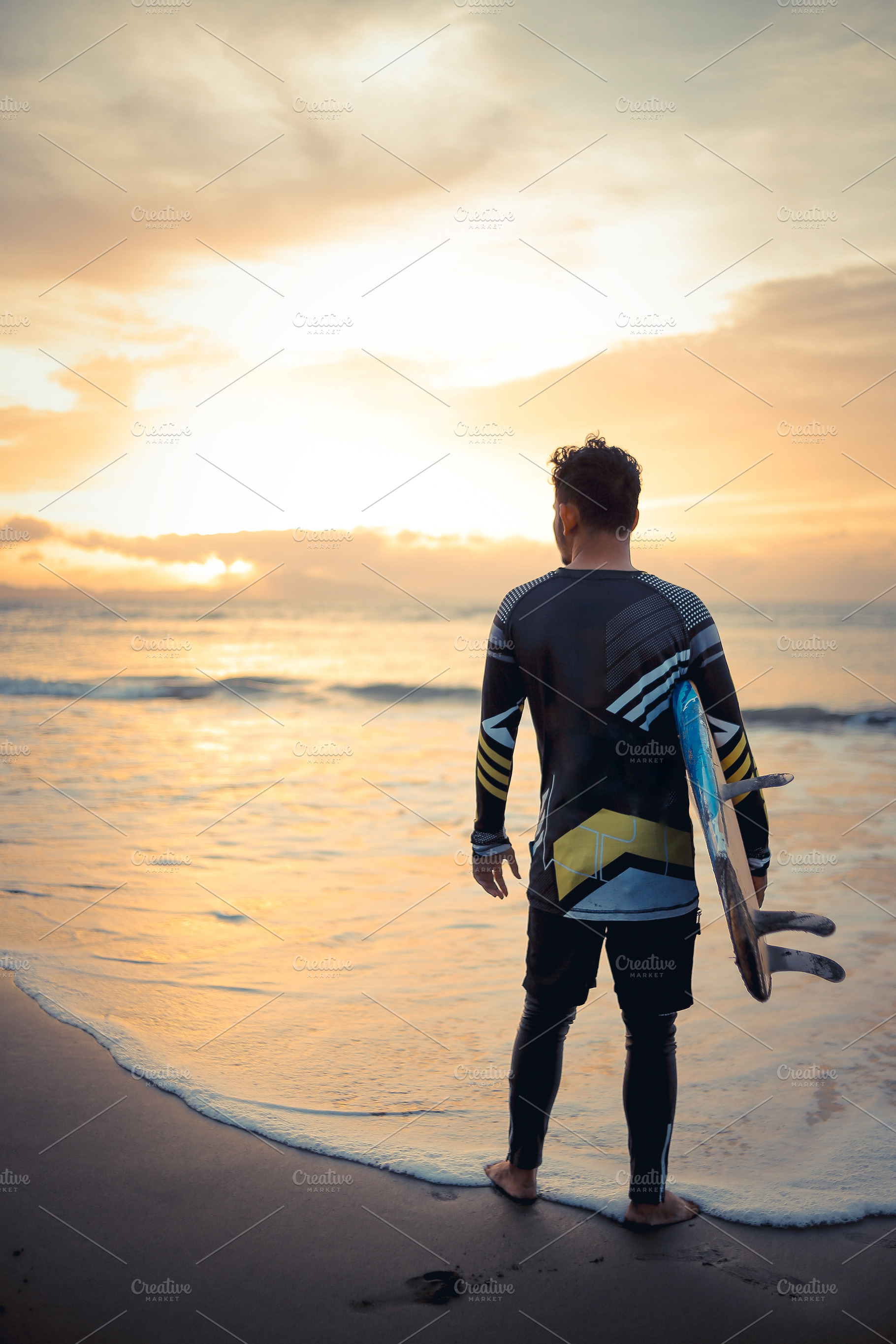 Surfer Watching Sunset at the Beach, a Photo by bastera