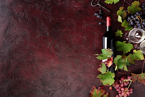 Red Wine Bottle with Grapes and Vine Leaves on Rustic Background, a Food & Drink Photo by Natalia Klenova's Shop