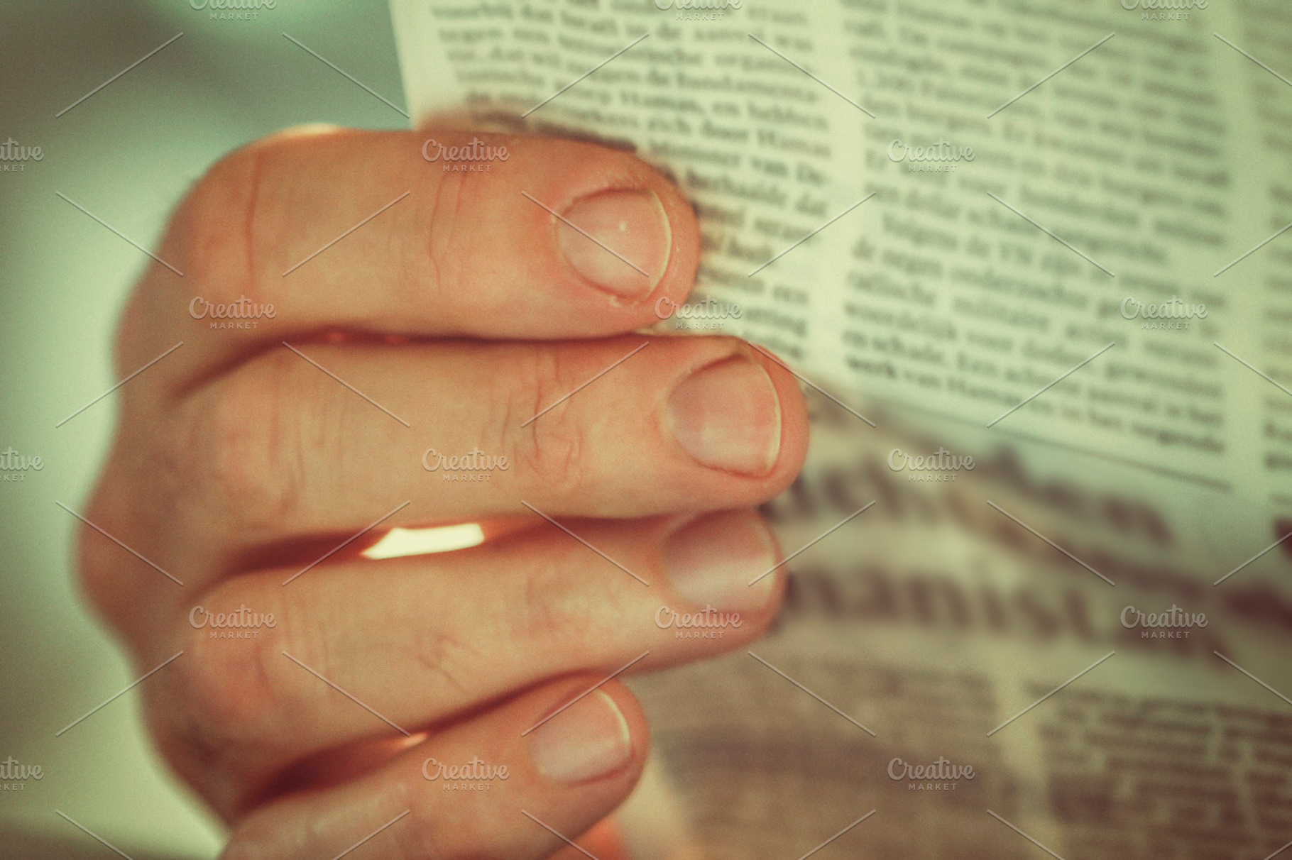 Hand holding newspaper, a School & Education Photo by Patricia Hofmeester