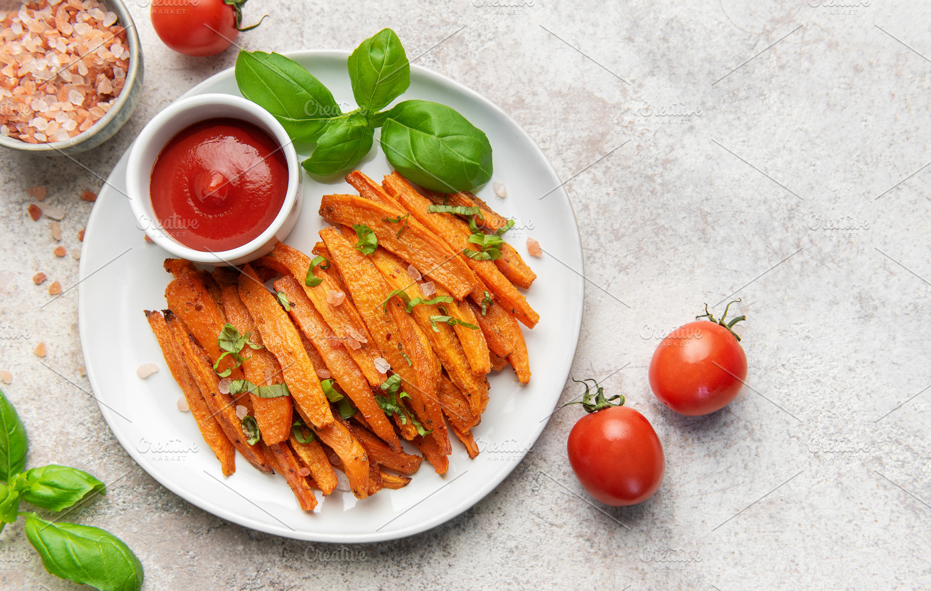 Sweet potato fries with ketchup and basil leaves, a Food & Drink Photo by Olena Rudo