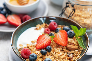 Healthy breakfast bowl with granola, yogurt, and berries, a Food & Drink Photo by Olena Rudo