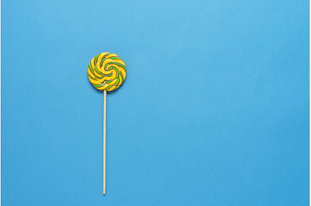 Striped lollipop yellow green on a, a Food & Drink Photo by Yulia71