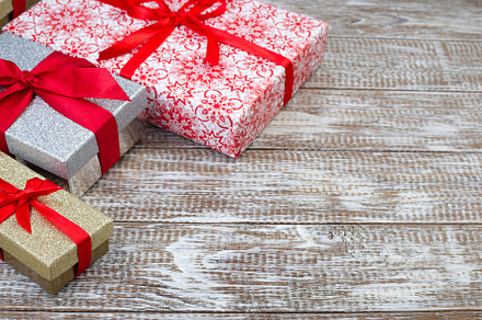 Different gift boxes, ribbons on table, preparing for Christmas, horizontal, co, a Holiday Photo by iuliia_n