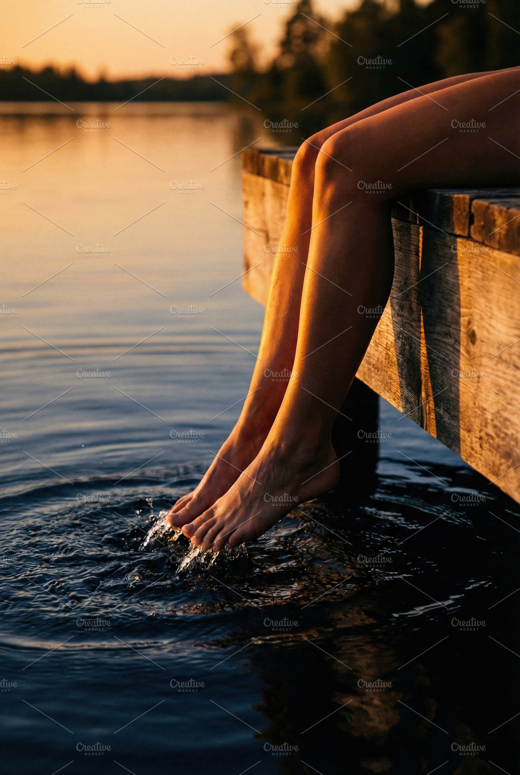 Legs Dipping in Tranquil Lake Water, a Person Photo by Virgo Studio