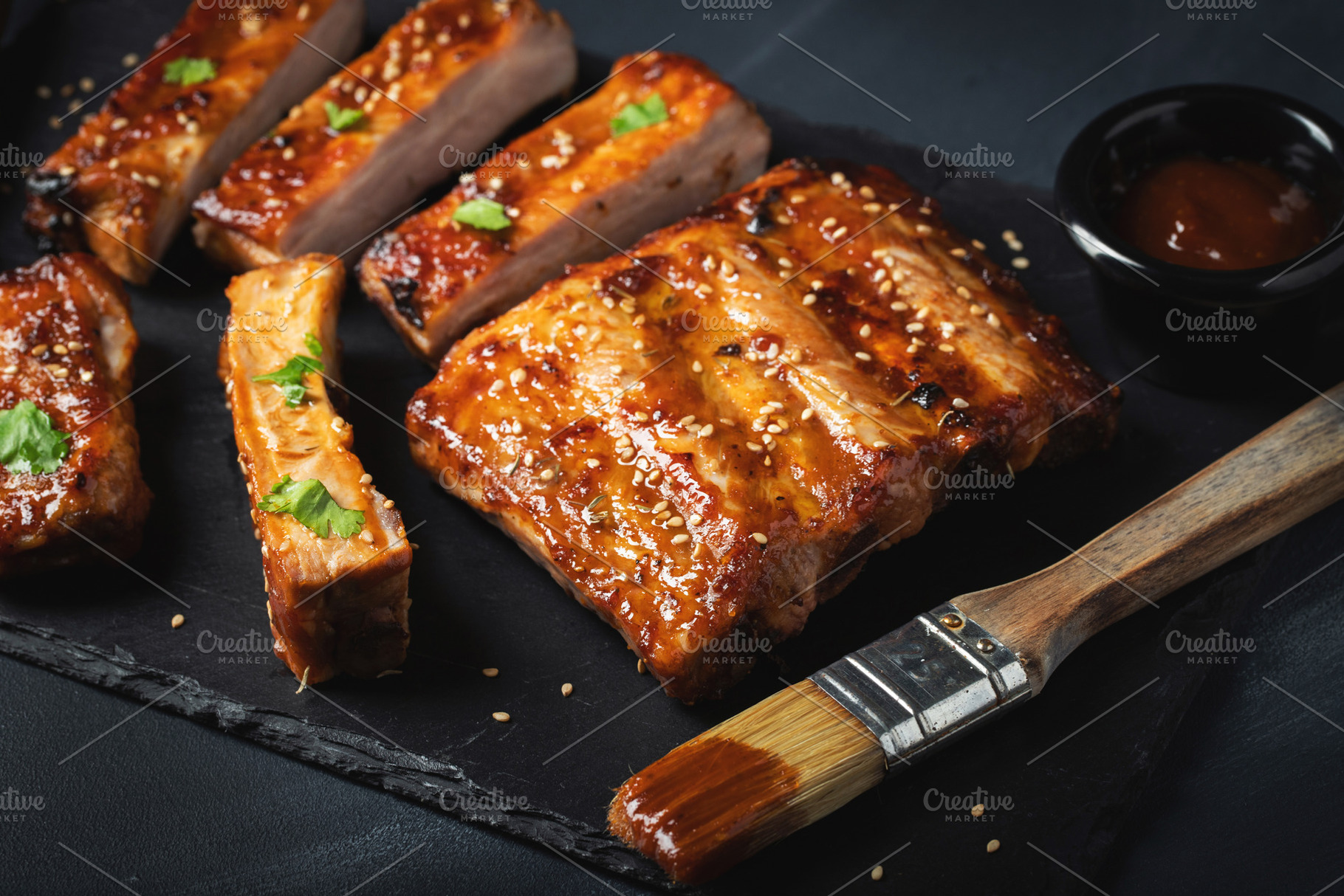 Barbecue pork spare ribs with hot honey chili marinade on black, a Food & Drink Photo by Budarinphoto