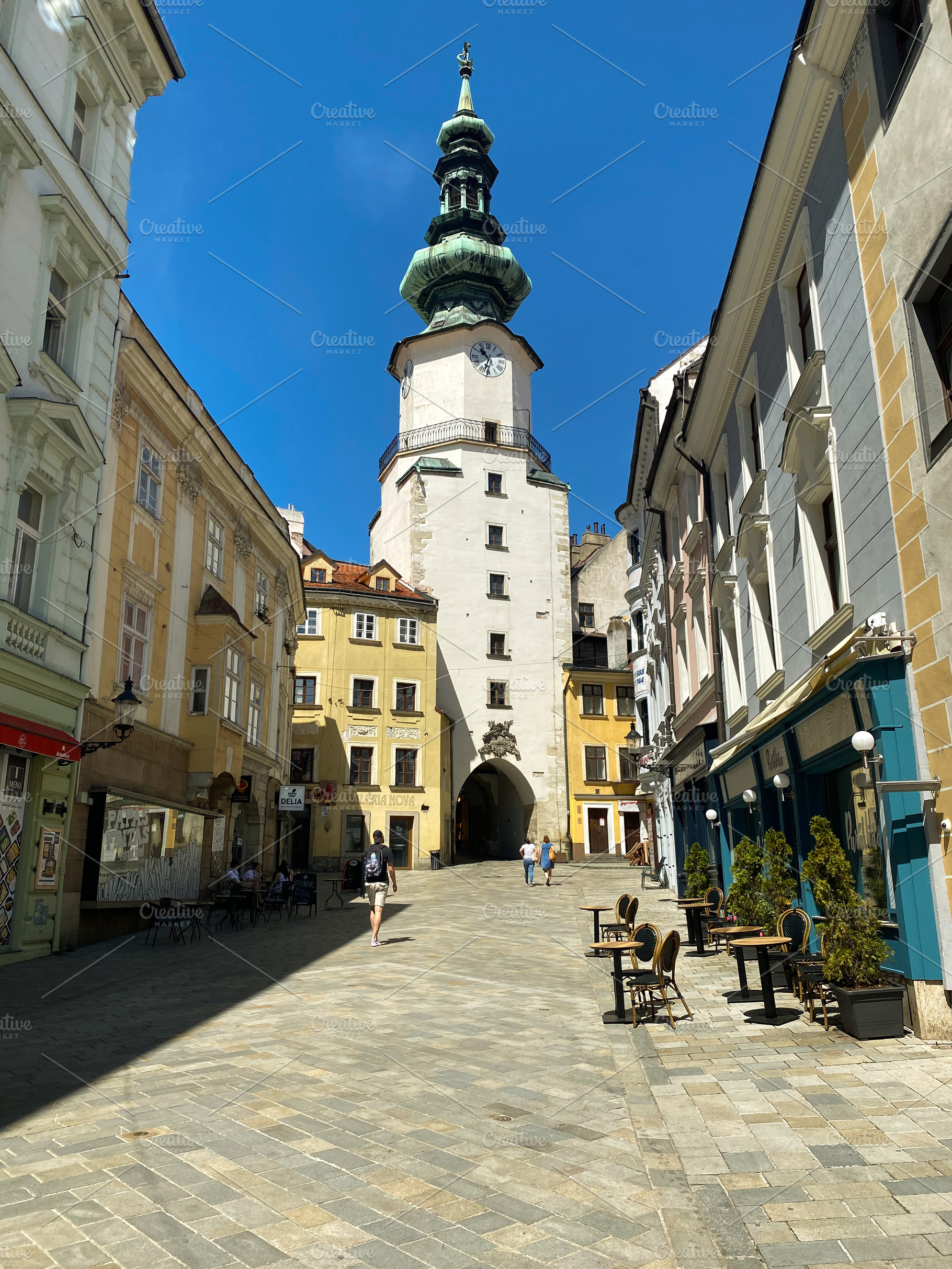 Historic street in Bratislava with St. Michael's Gate under a cl, a Holiday Photo by sebastianaraw