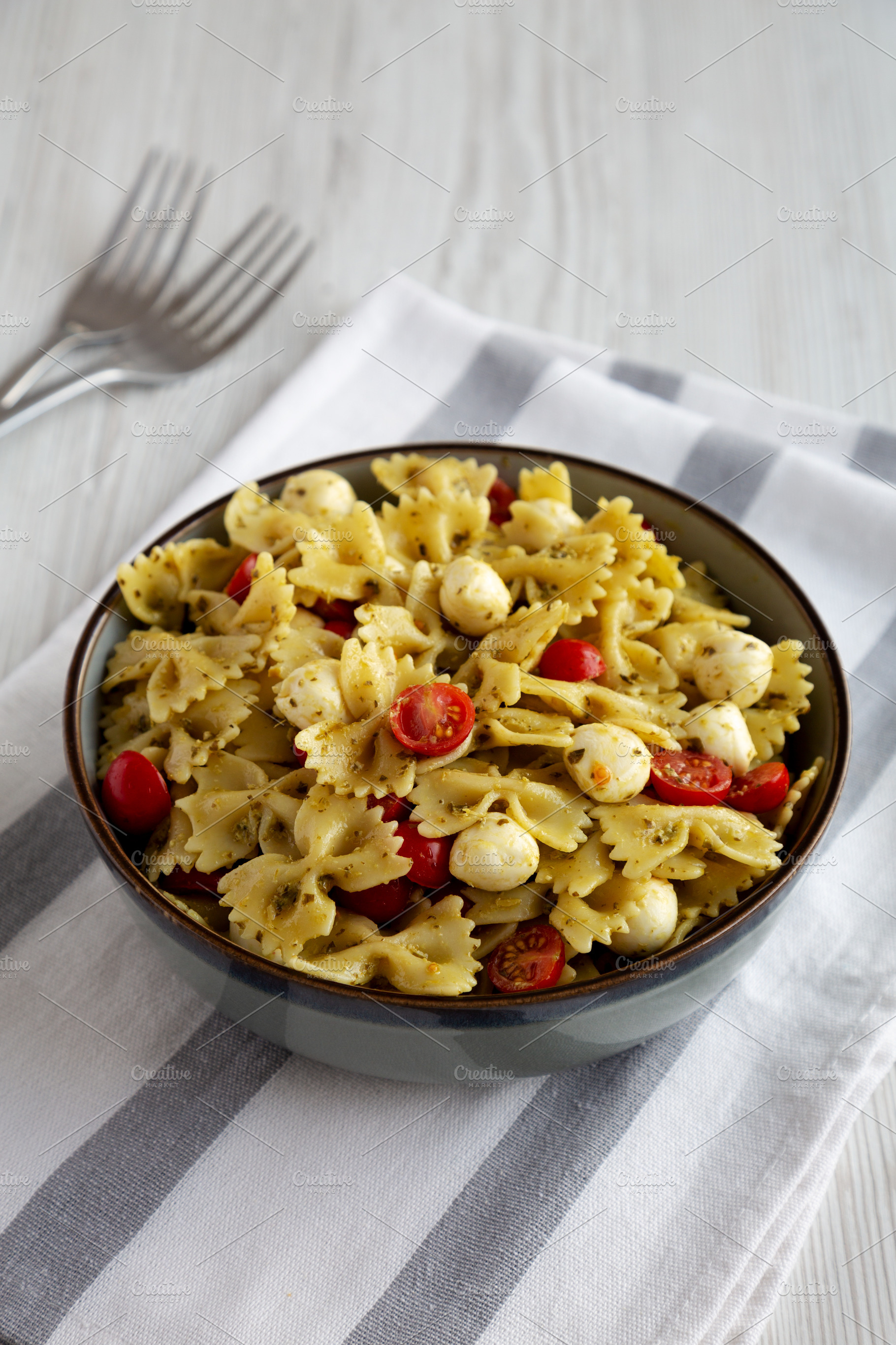 Homemade Pesto Pasta with Tomatoes ans Mozzarella in a Bowl, sid, a Food & Drink Photo by LiudmylaChuhunova