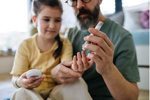 Father assisting his daughter with, a Health & Medical Photo by HalfPoint