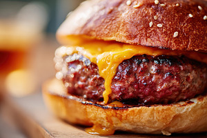 Juicy cheeseburger with melting cheddar, a Food & Drink Photo by AlyaAnd