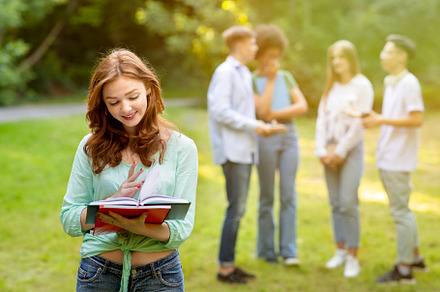 Beautiful female student holding not, a Photo by Prostock-Studio
