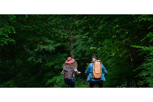 Travellers couple going on e-bike, a Person Photo by HalfPoint