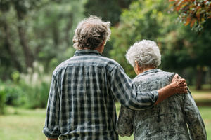 Elderly couple walking in a park