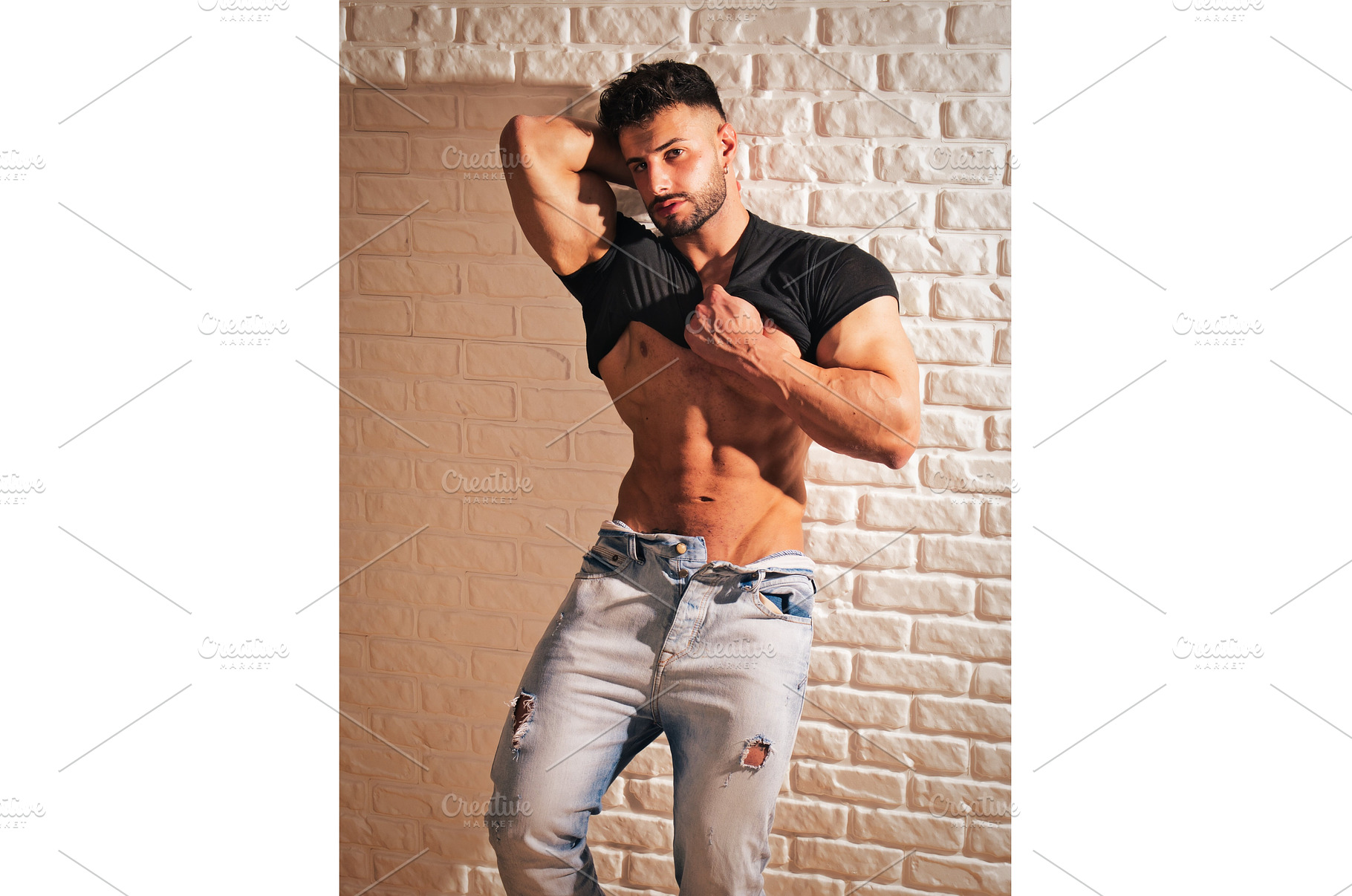 Muscular handsome man against brick, a Person Photo by ArtOfPhotos photo store