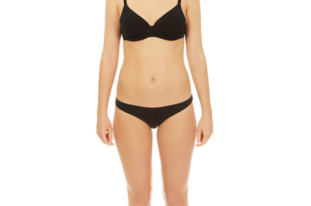 Happy woman standing in bikini.