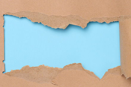 Torn edges of brown paper on a blue background, space for writin, a Background Photo by ndanko