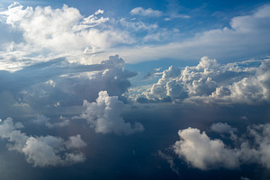 Dramatic sky with sunbeams and clouds seen from an airplane, a Nature Photo by GoodGoods
