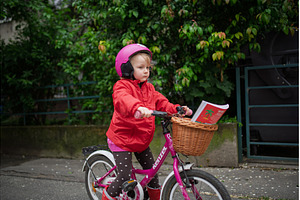 Little girl riding pink bike with, a Transportation Photo by HalfPoint