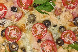 Close-up of delicious pizza with tomato, olive, bacon, chicken,, a Food & Drink Photo by ndanko
