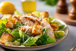 Fresh caesar salad with grilled chicken and croutons, a Food & Drink Photo by AlyaAnd