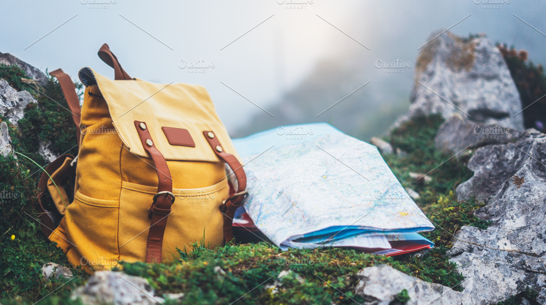 Yellow backpack and map, a Background Photo by A_B_C