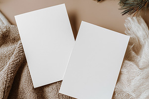 Blank vertical invitation cards mockup on cozy woolen knit and soft fabric with, a Holiday Photo by Studio ANNA