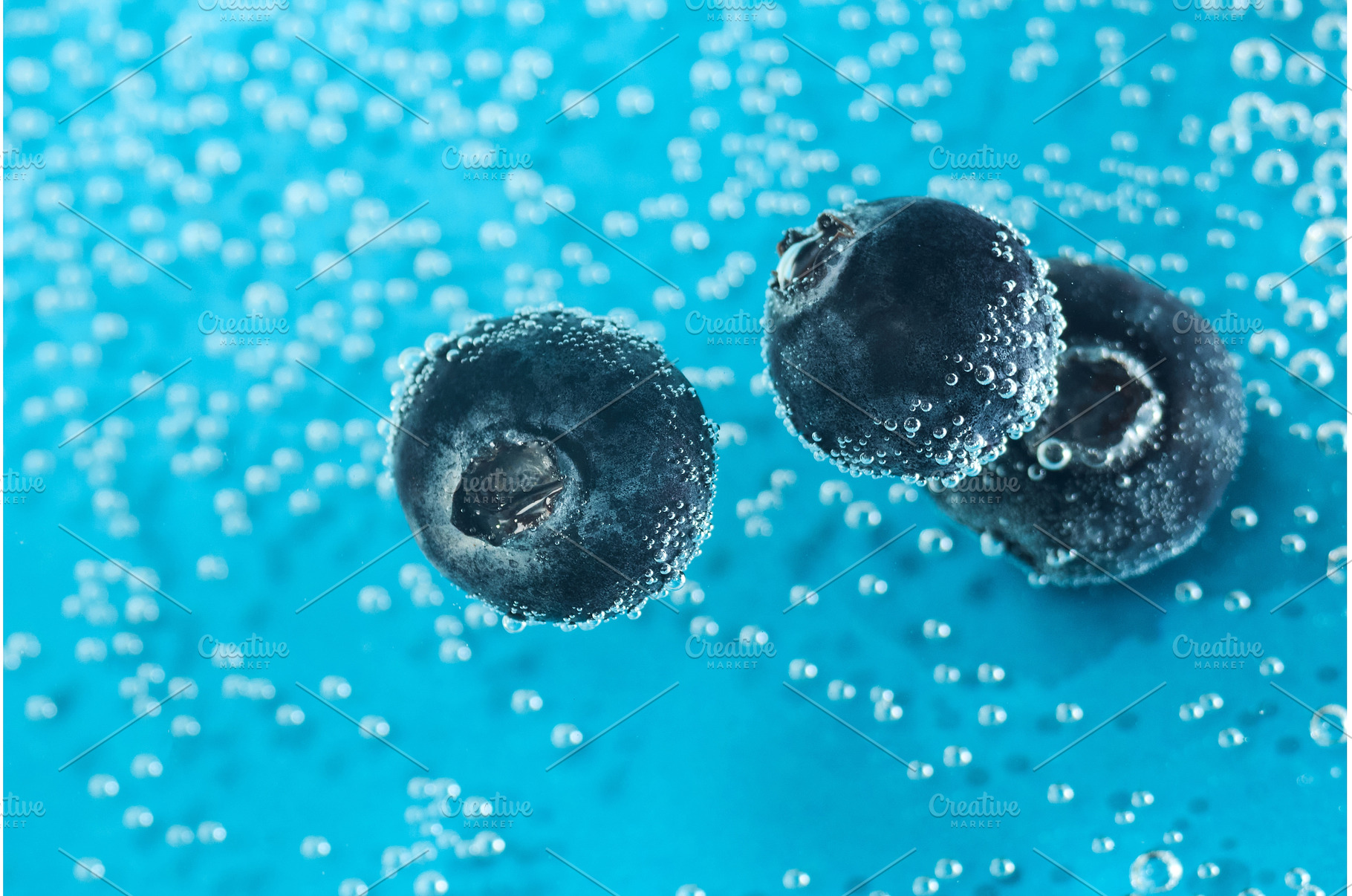 Fresh blueberries float in sparkling, a Food & Drink Photo by darksoul72