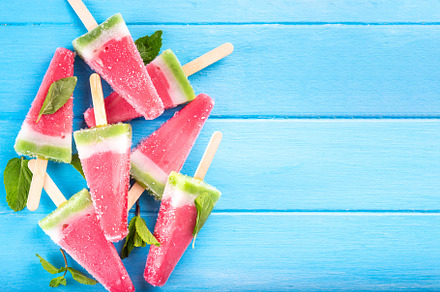 Tasty sweet watermelon ice cream lollies on blue wooden table, a Food & Drink Photo by Rimma
