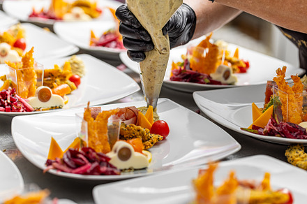Chef is garnishing delicious appetizer dishes, a Photo by Grafvision photography