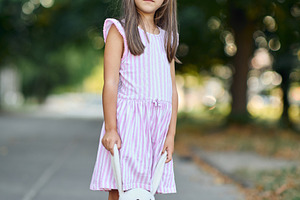 Full length portrait of a cute little girl standing on a sidewalk holding a plu, a Person Photo by Rohan Photography