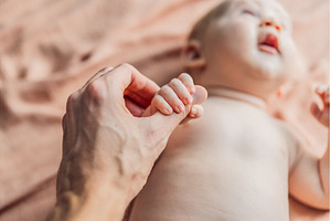 Loving father gently holds his, a Person Photo by Elizaveta Galitskaya