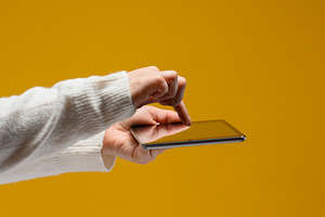 Female hands in a white sweater hold an electronic tablet horizo, a Technology Photo by ndanko