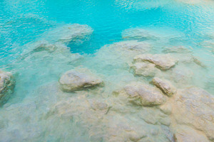 Surface of emerald blue water of tropical lake, a Nature Photo by Vapi