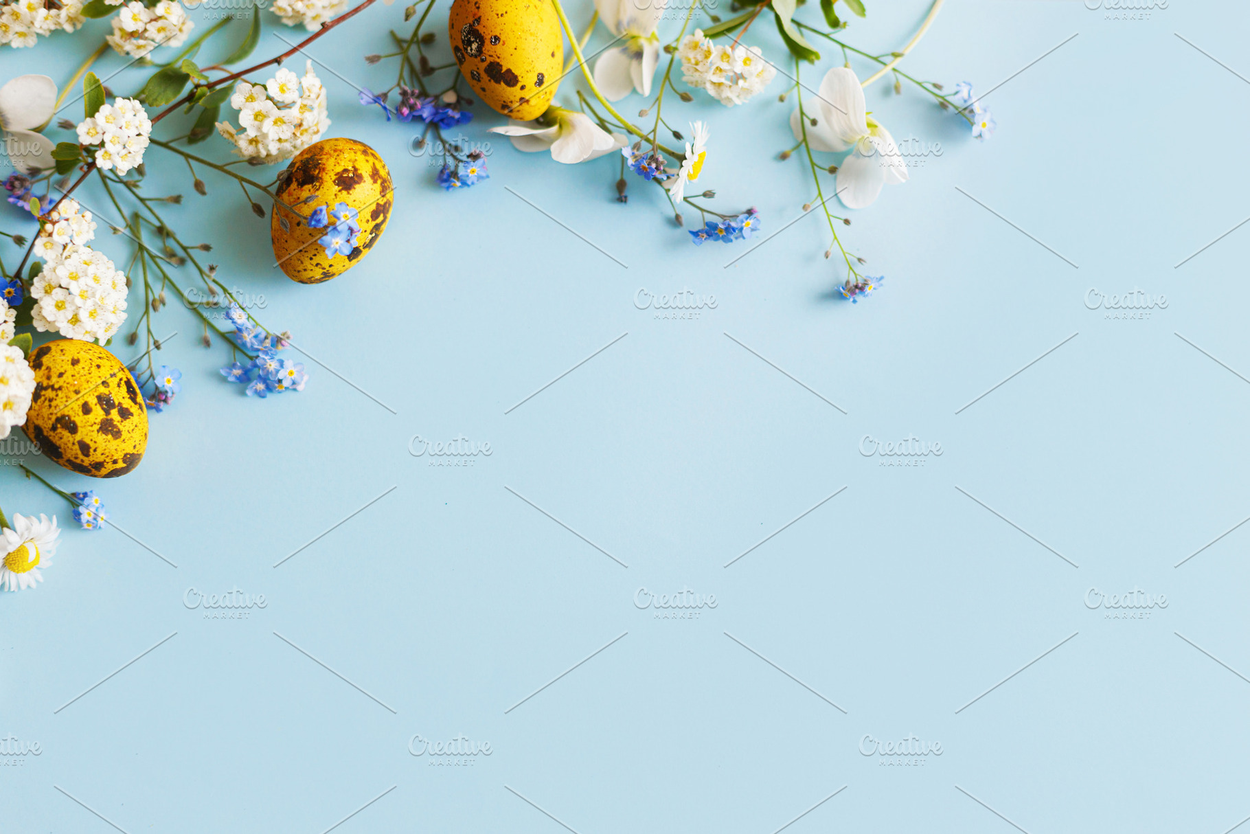 Easter flat lay. Stylish easter eggs and spring flowers on blue, a Holiday Photo by Sonjachni