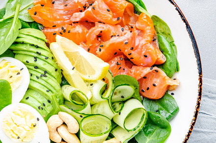 Keto salad bowl with salmon, avocado, spinach, cucumber, eggs, c, a Food & Drink Photo by 5PH
