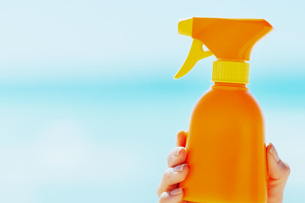 Closeup on bottle of sun screen creme in hand of woman, a Person Photo by Alliance Images