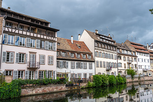 Half timbered houses by the river in Strasbourg, France, an Architecture Photo by GoodGoods