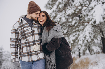 A young happy and loving couple walking in a winter snowy forest, a Person Photo by Cherkas Photography