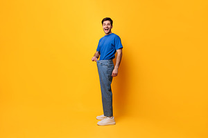 Happy Man Pulling His Old Large Loose Jeans