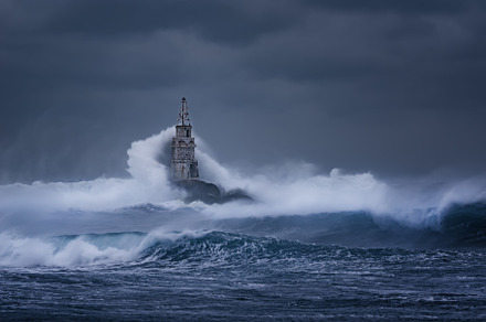 Big wave against old lighthouse featuring lighthouse, storm, and stormy