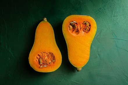 Small pumpkins on green background