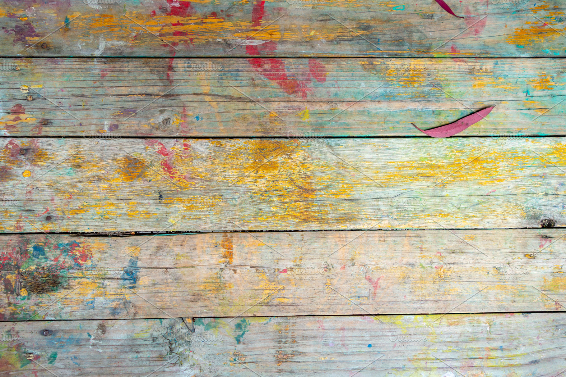 Rustic wooden surface with colorful paint splashes and marks, an Architecture Photo by GoodGoods
