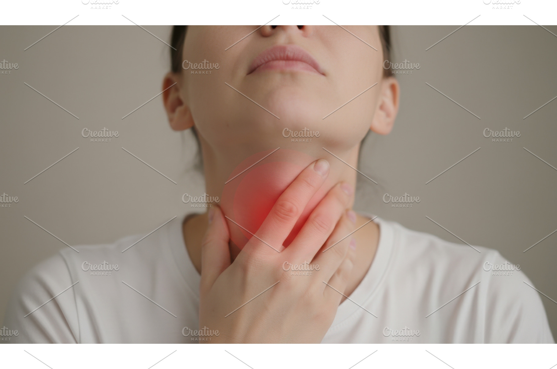 Woman touching her neck with glowing, a Health & Medical Photo by Igor Tichonow